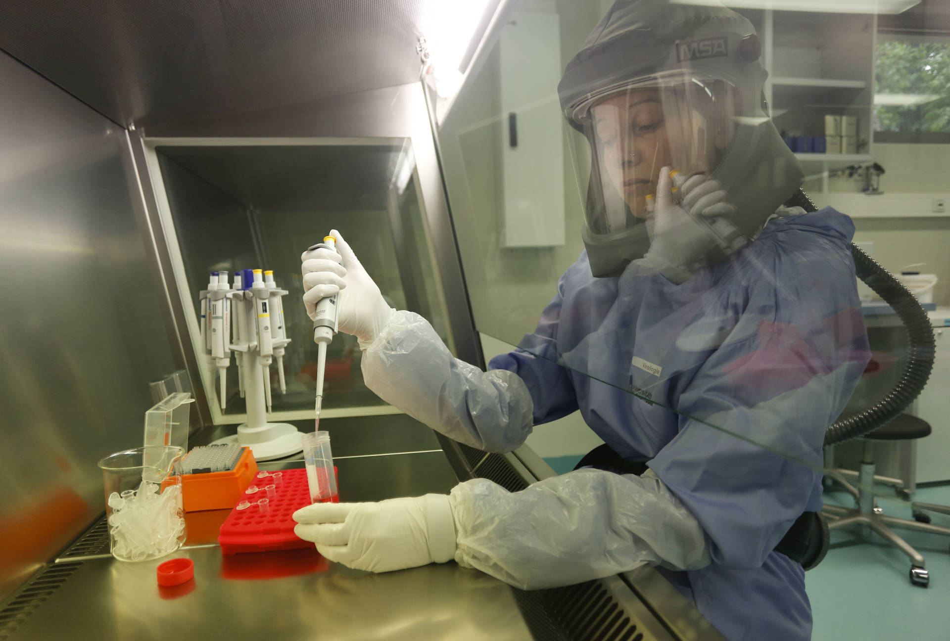 Scientist in the BSL3-4 virology laboratory